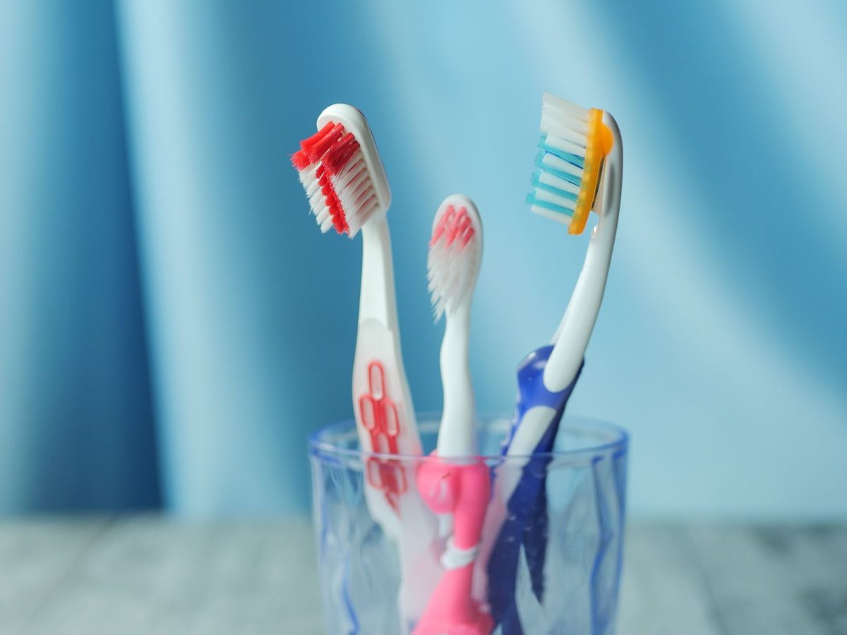Colorful children's toothbrushes in a cup